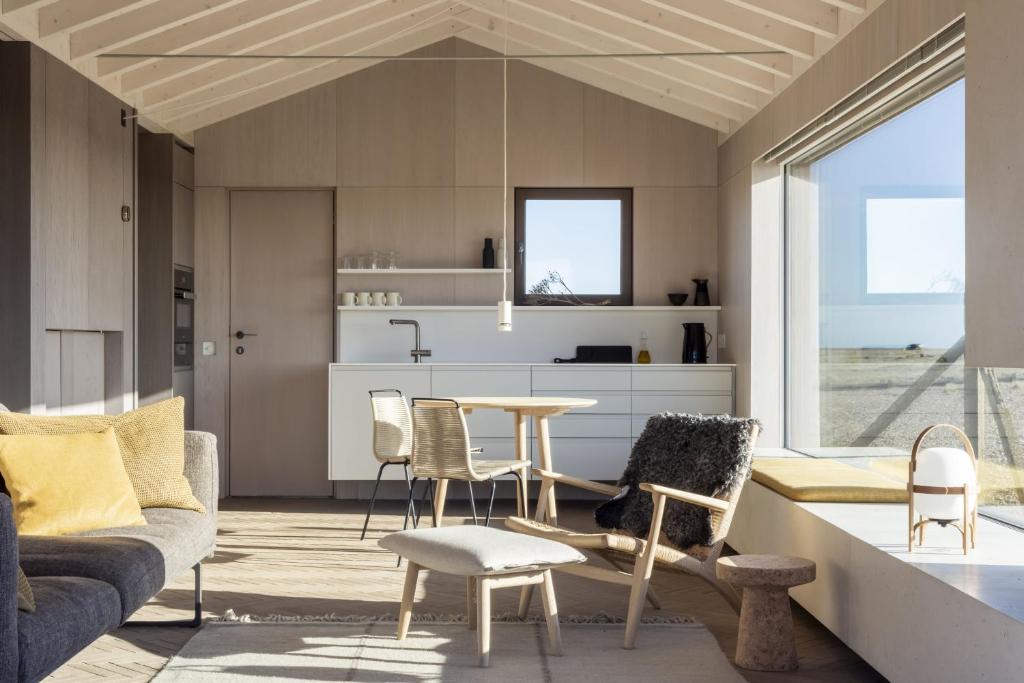 a living room with a couch and a table and chairs at Radar by Bloom Stays in Littlestone-on-Sea