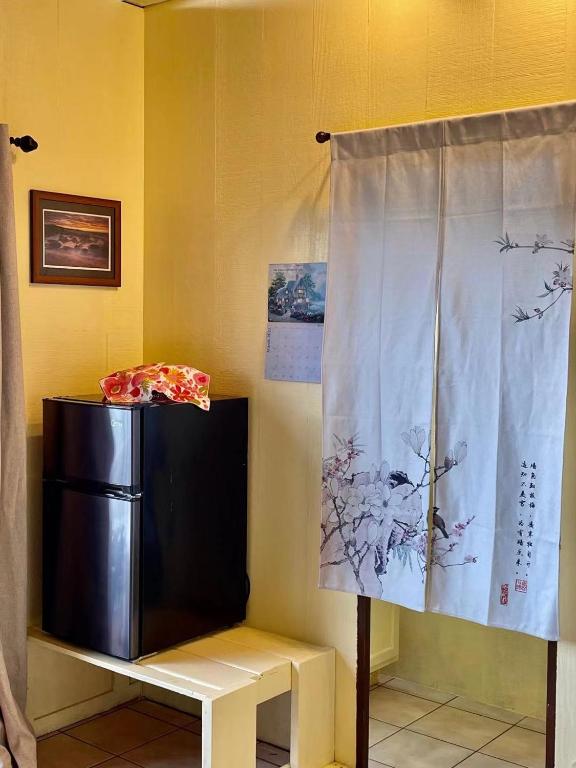 a curtain in a room with a refrigerator at Coffee Garden in Captain Cook