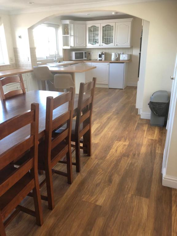 a kitchen and dining room with a table and chairs at Henry,s Place in Great Torrington