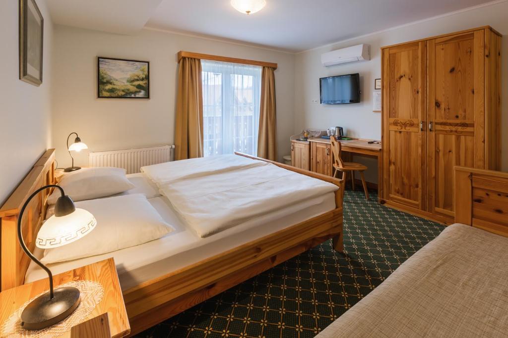 Postel nebo postele na pokoji v ubytování Penzion Kaps