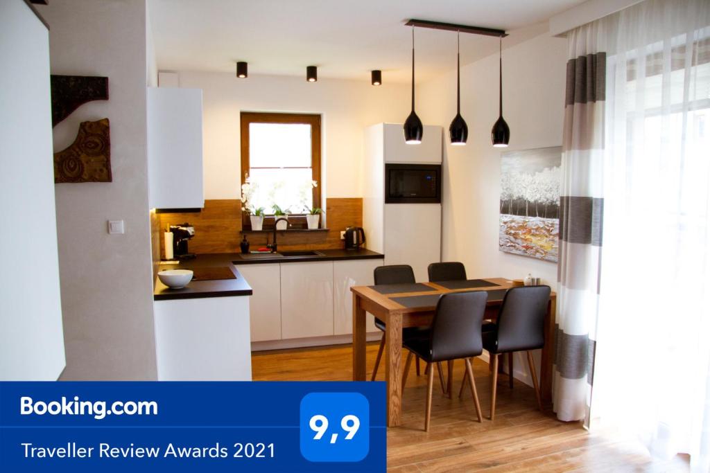 a kitchen and dining room with a table and chairs at Apartament Góralka in Jaworki
