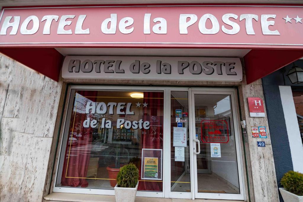 a store front of a store with a sign on it at Hôtel de La Poste in Douvaine
