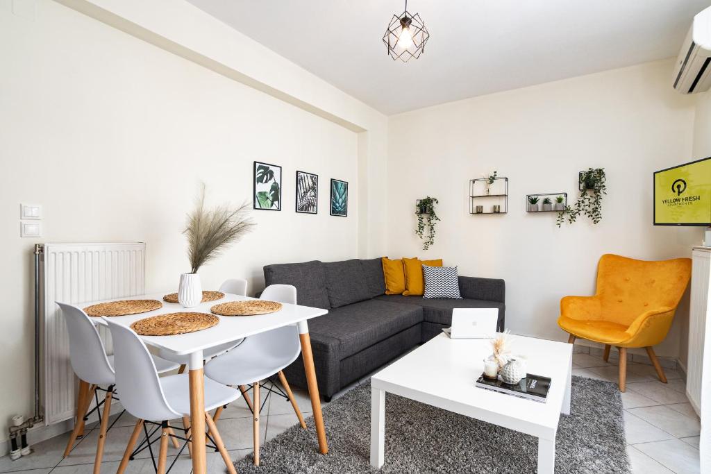 a living room with a couch and a table at Yellow Fresh Apartment 2 in Alexandroupoli
