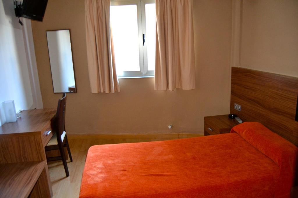 Postel nebo postele na pokoji v ubytování Hotel El Cruce Moraleda