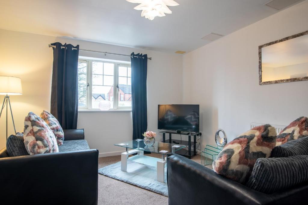 a living room with two couches and a tv at No10 Nursery Convent in Mansfield