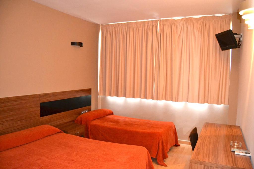 Postel nebo postele na pokoji v ubytování Hotel El Cruce Moraleda