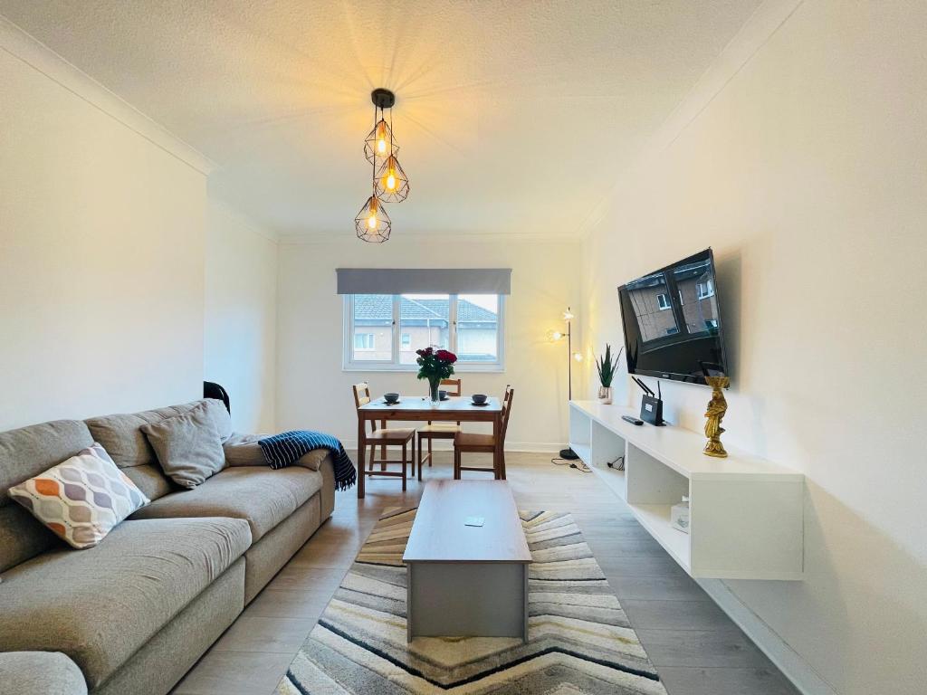 a living room with a couch and a table at Cardonald Central in Glasgow