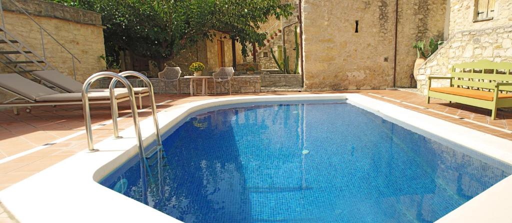 a swimming pool with blue water in a yard at Villa Irini in Vafés