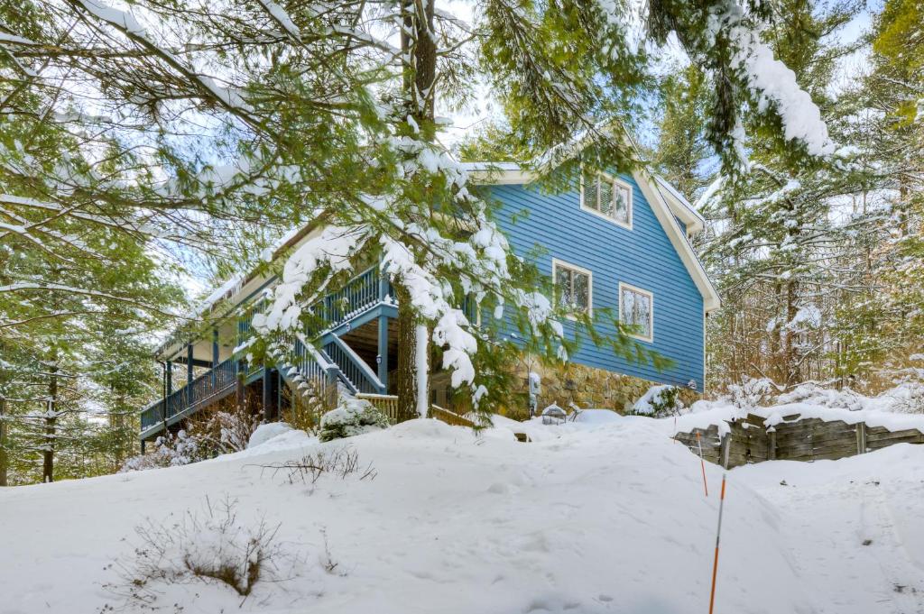 a blue house in the snow at Tall Pines in Swanton