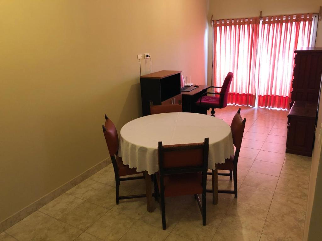 a dining room with a white table and chairs at Departamento Salta Capital in Salta
