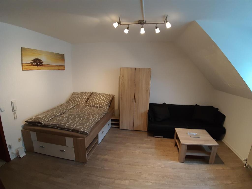a small room with a bed and a couch at Apartment in Abstatt mit 5min zur A81 in Abstatt