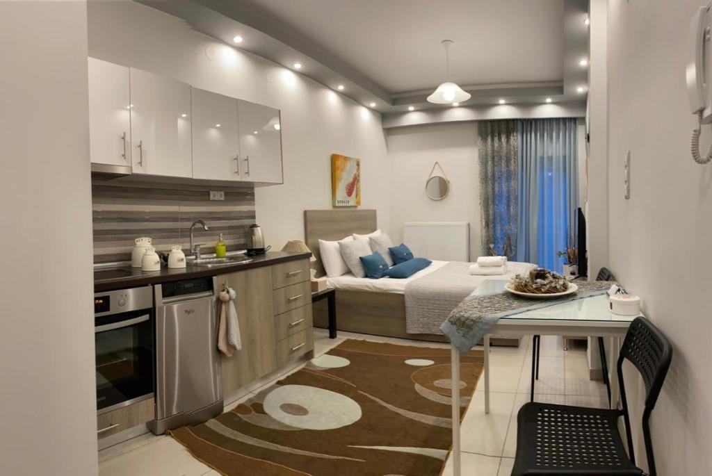 a small kitchen and a bedroom with a bed at Xenia_Apartments A2 in Kozani