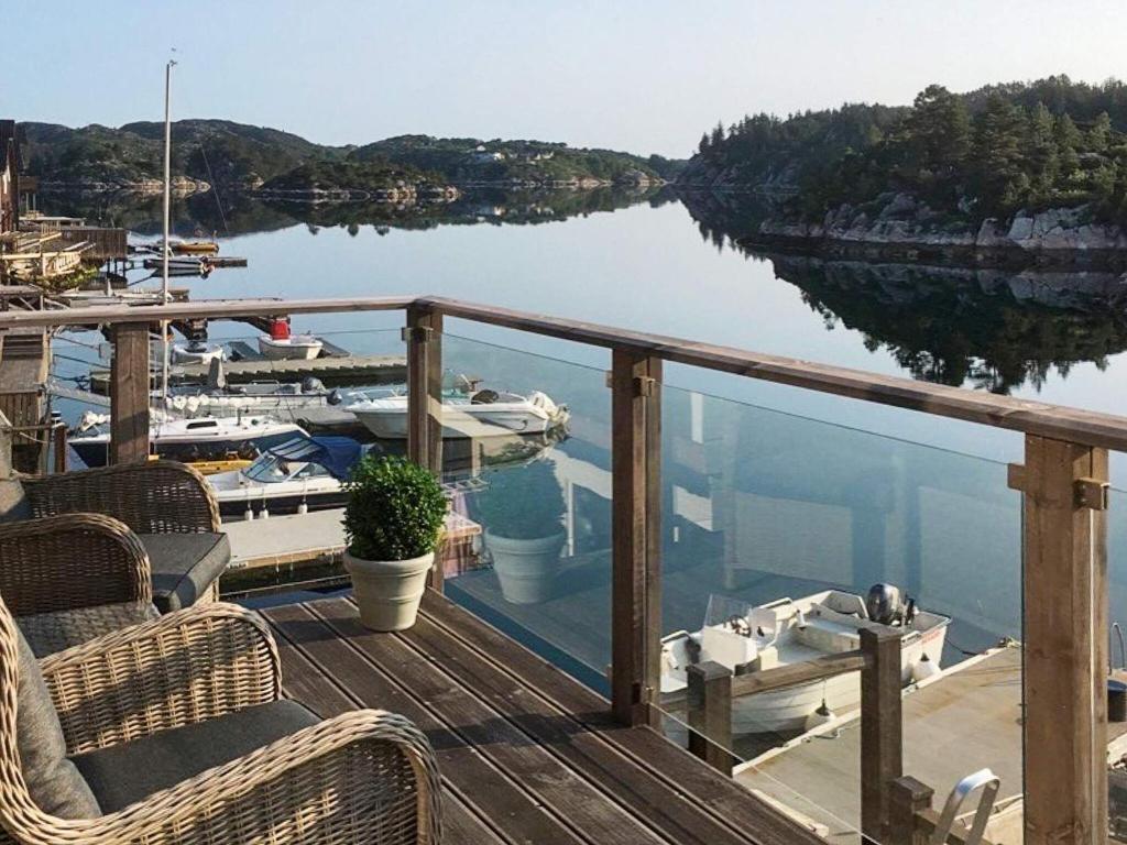 a deck with chairs and boats in a marina at 8 person holiday home in Urangsv g in Ervik