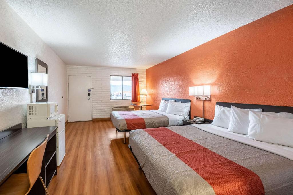 a hotel room with two beds and a flat screen tv at Motel 6-Eloy, AZ - Casa Grande in Eloy