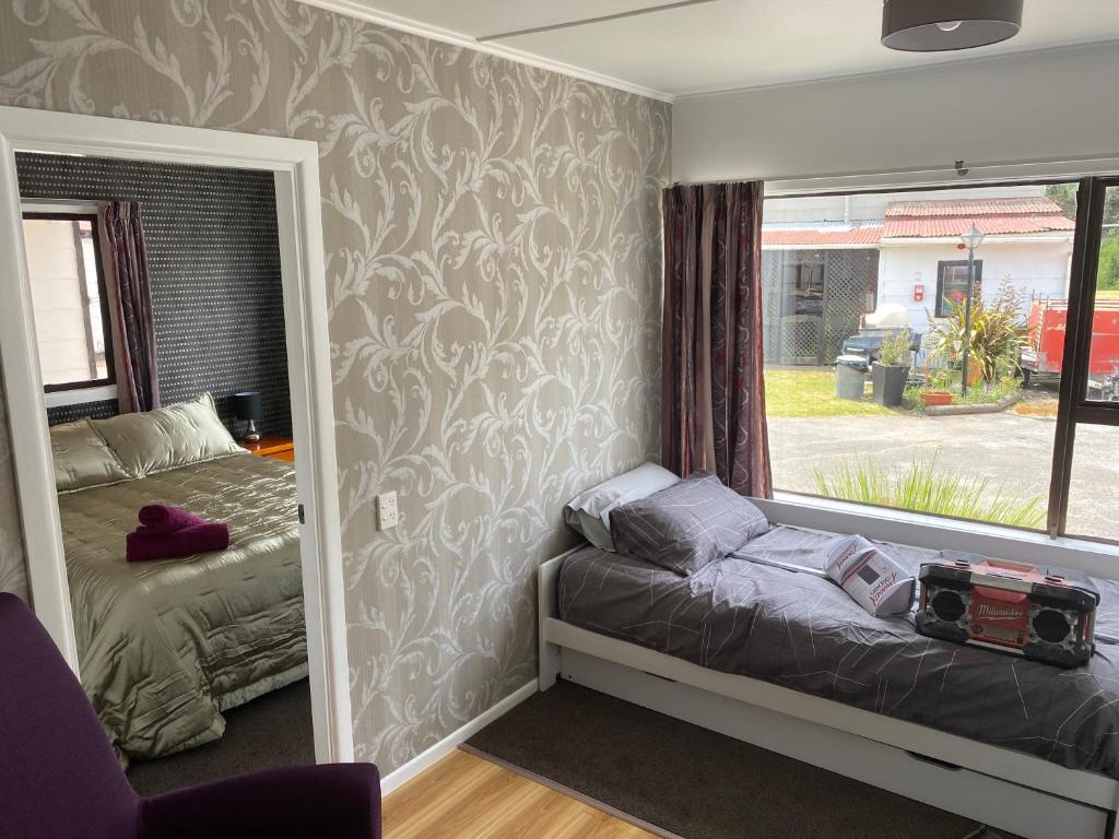 Postel nebo postele na pokoji v ubytování Windsor Motel