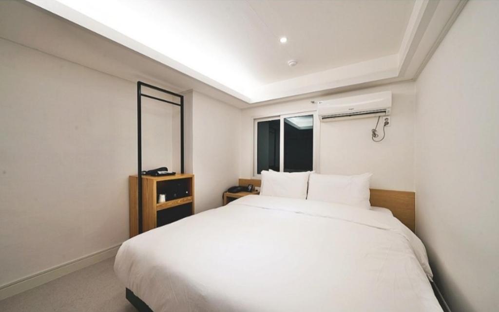 Postel nebo postele na pokoji v ubytování Busan Seomyeon Business Hotel J7