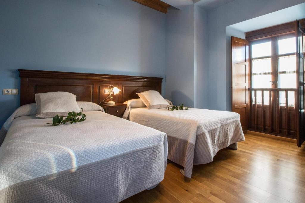 Postel nebo postele na pokoji v ubytování La Casona de Amaido