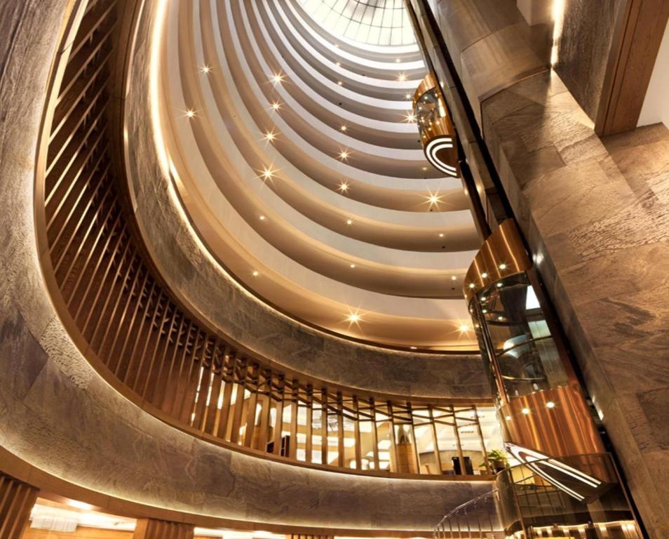 a spiral staircase in a building with a ceiling at Surmeli Istanbul Hotel in Istanbul