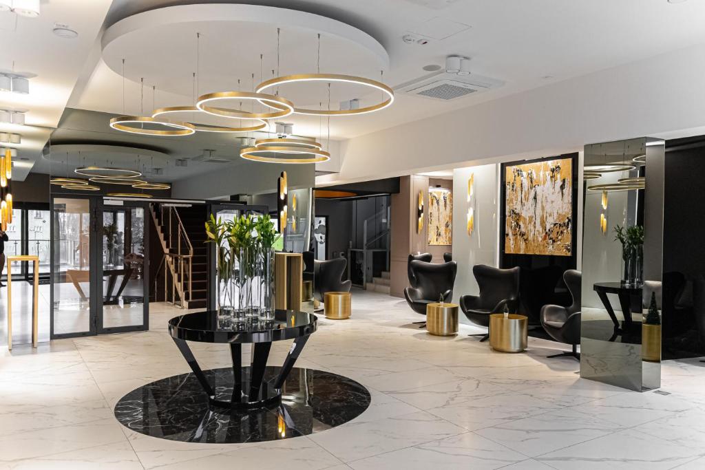 a lobby with a vase of flowers on a table at Trofana Wellness & SPA in Międzyzdroje