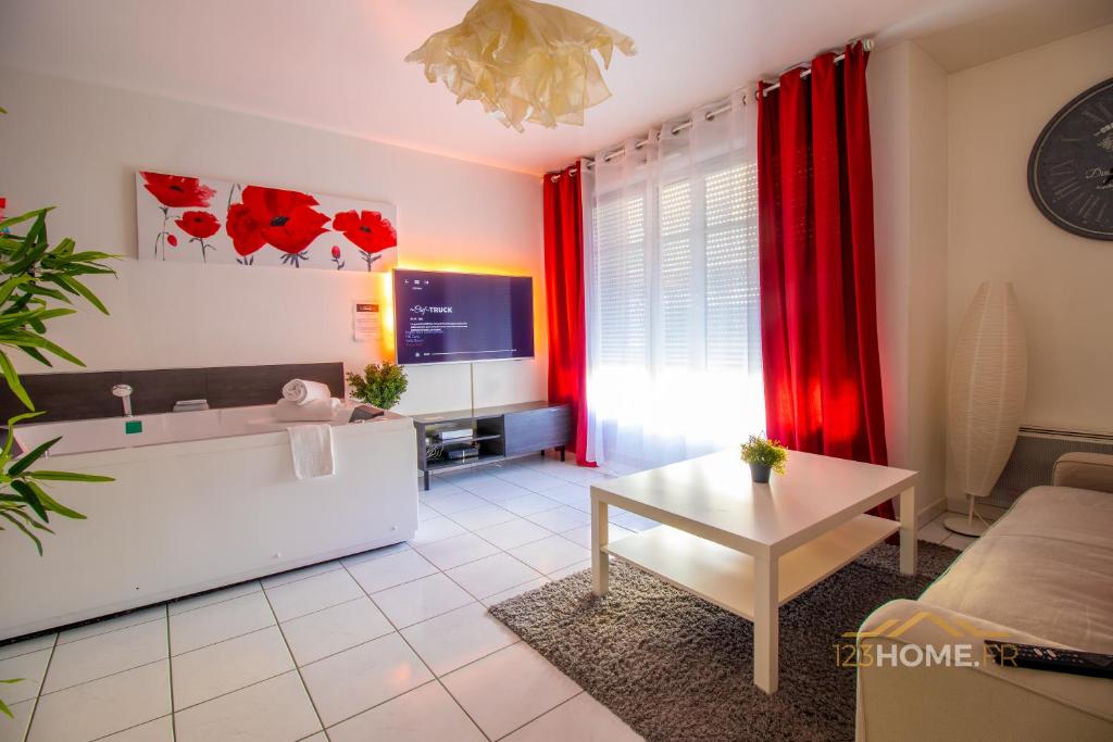 a living room with a tub and red curtains at 123home-Loft & spa in Montévrain