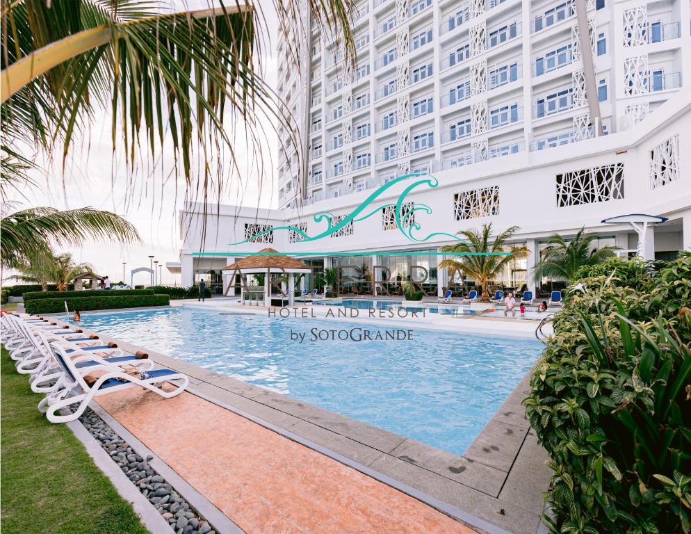 a pool at the hotel and resort in singapore at Arterra Hotel and Resort in Mactan