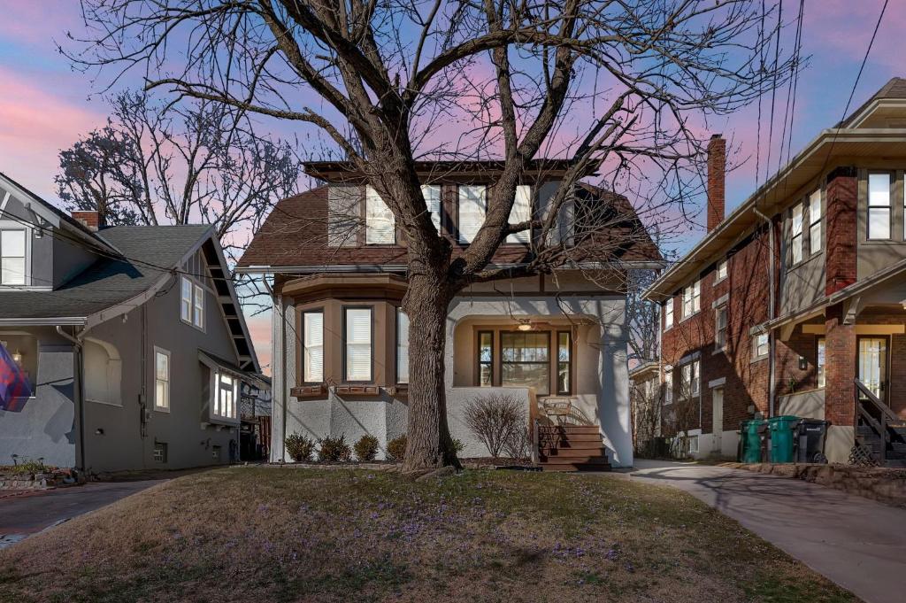 a house with a tree in the front yard at Oakley Square 3BR Charmer - Total Walkability home in Cincinnati
