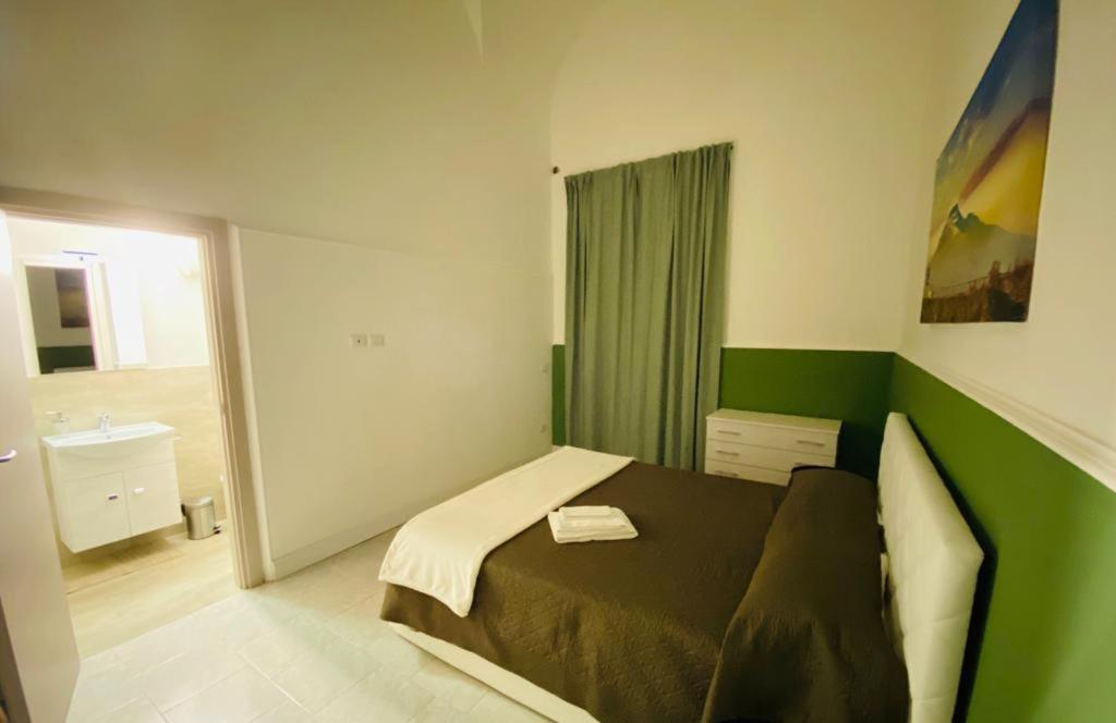 A bed or beds in a room at Il Vicolo Home 2
