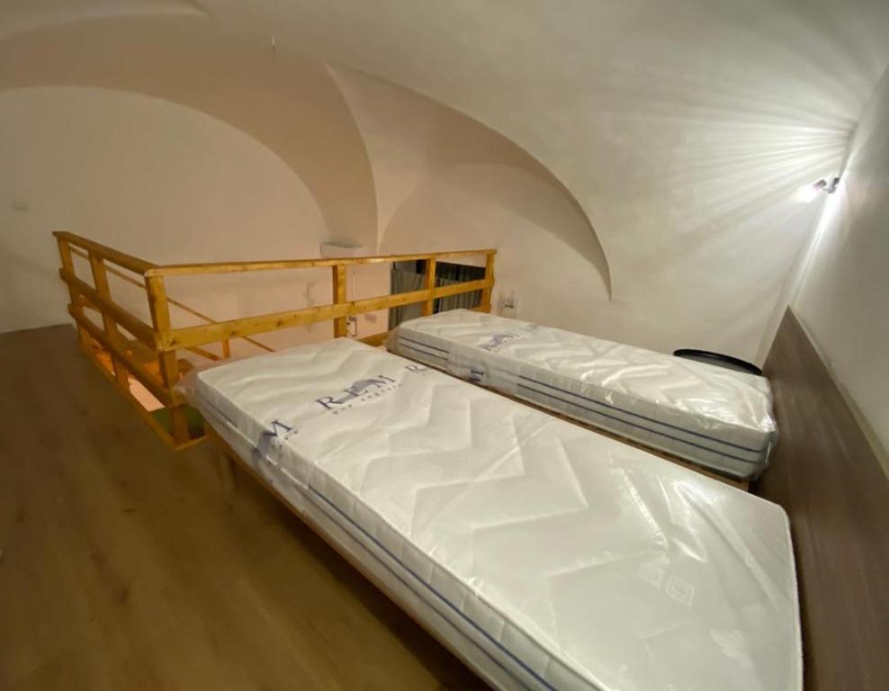 A bed or beds in a room at Il Vicolo Home 2