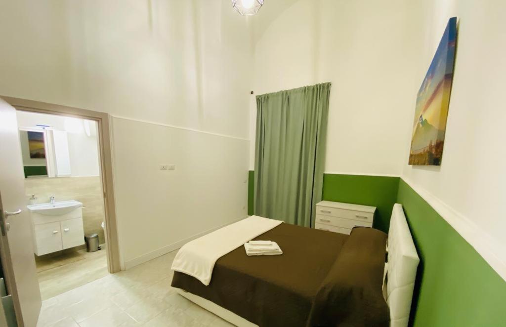 A bed or beds in a room at Il Vicolo Home 2