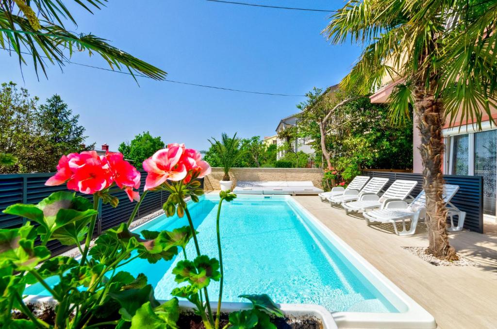 a swimming pool in the backyard of a house at Abros potkrovlje in Crikvenica