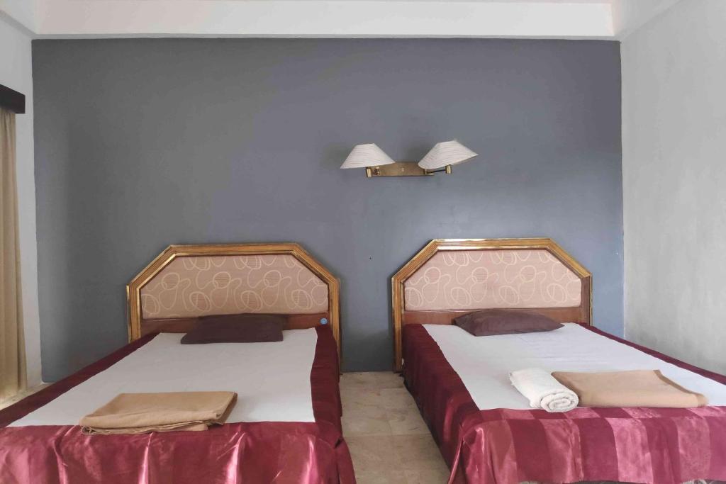 Ένα ή περισσότερα κρεβάτια σε δωμάτιο στο Pecatu GuestHouse