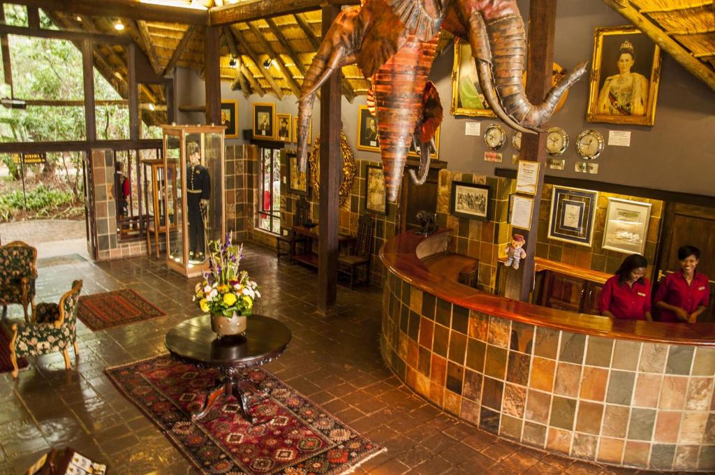 a restaurant with a dinosaur on the wall at Kedar Heritage Lodge, Conference Centre & Spa in Phokeng