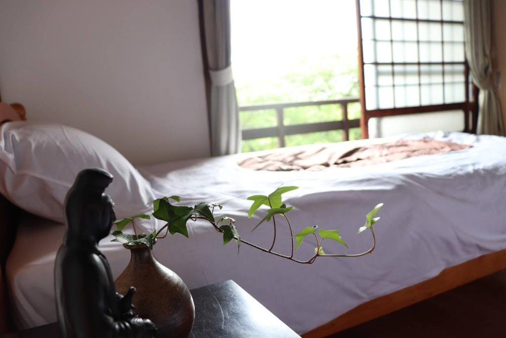 Postel nebo postele na pokoji v ubytování Guesthouse Sakichi