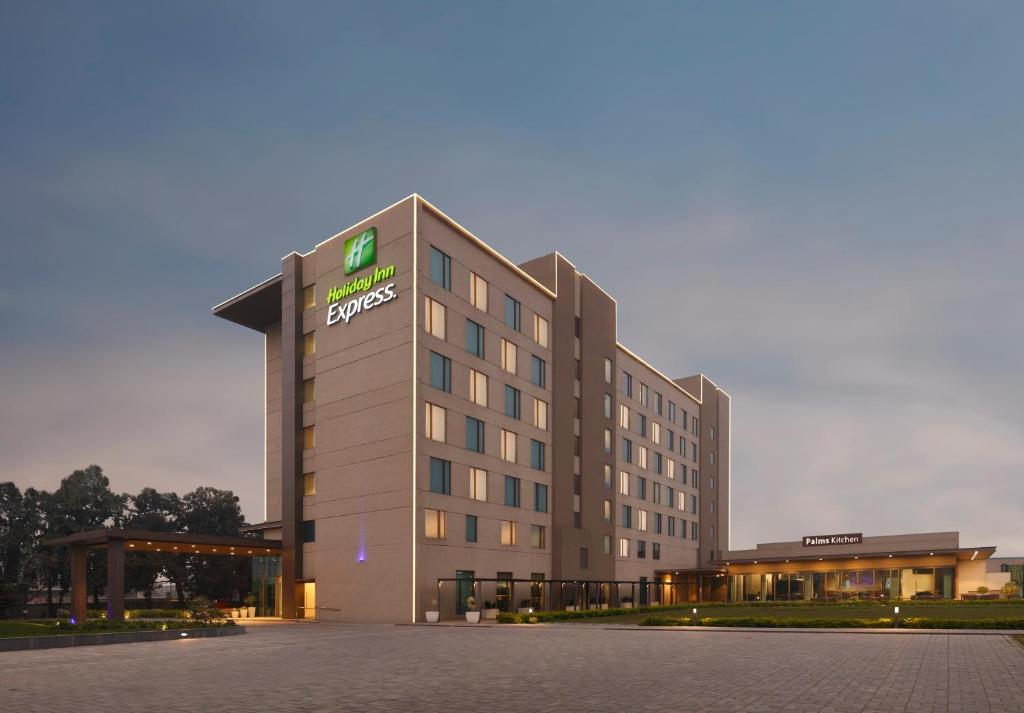 a hotel building with a sign on the front of it at Holiday Inn Express Kolkata Airport, an IHG Hotel in Kolkata