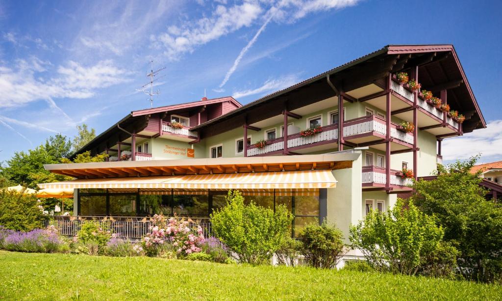 a large building with flowers in front of it at Thermenhotel Ströbinger Hof in Bad Endorf