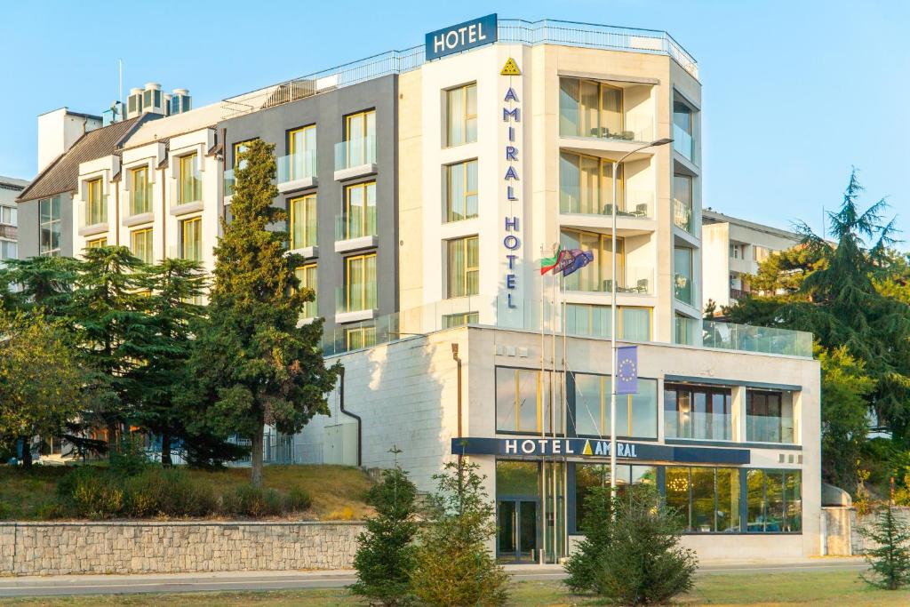 a hotel building with a sign in front of it at Amiral Hotel (former Best Western Park Hotel) in Varna City