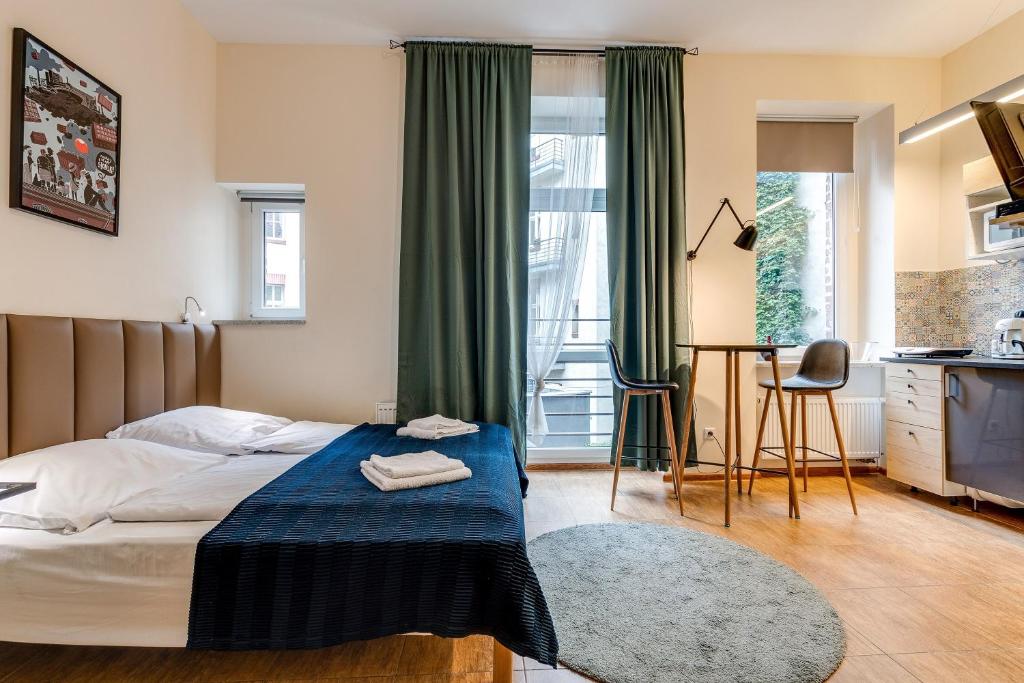 Postel nebo postele na pokoji v ubytování Mickiewicza Suites