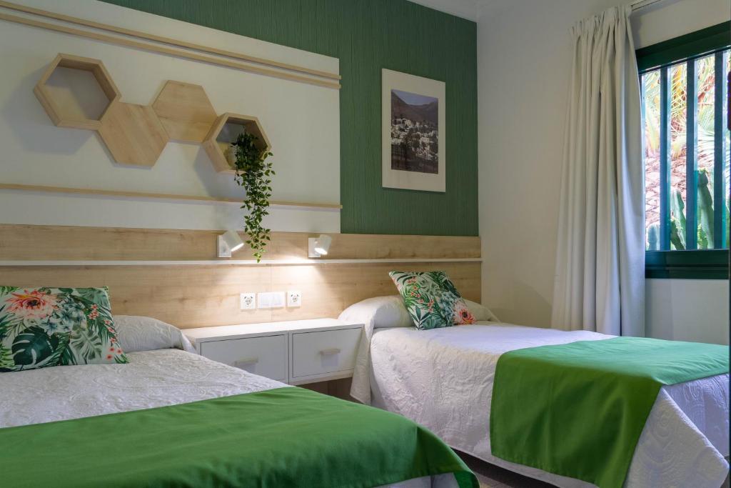 Postel nebo postele na pokoji v ubytování Apartamentos La Tegala