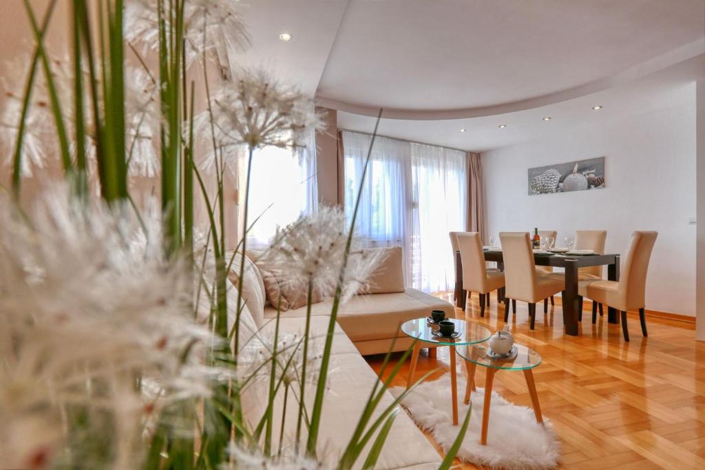 a living room with a couch and a table and chairs at Zadar Dream Holiday Apartment in Zadar