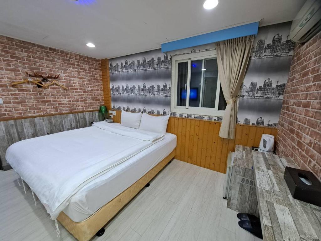 Postel nebo postele na pokoji v ubytování Bin Chen Business Hotel