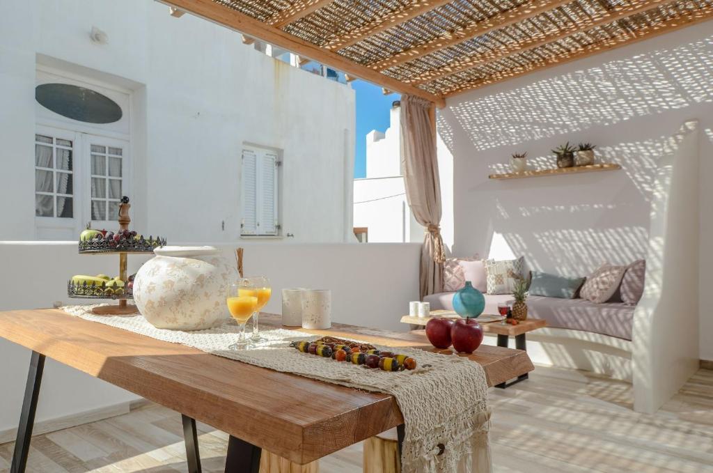 a living room with a table with fruit on it at Aegean White Home in Naxos Chora