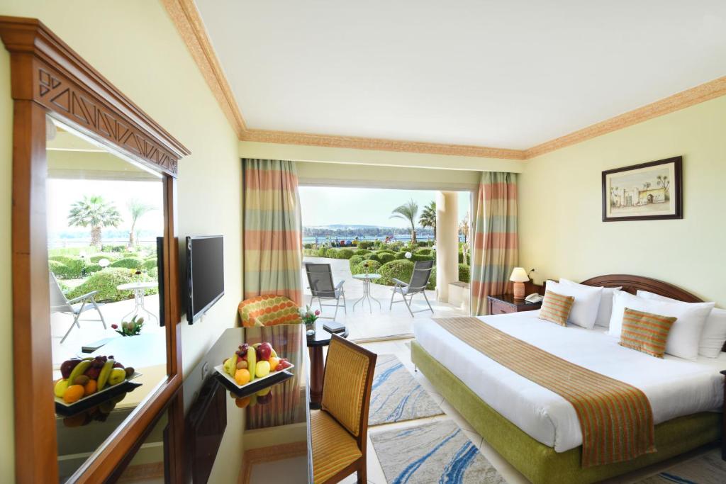 a hotel room with a bed and a balcony at Tolip Aswan Hotel in Aswan