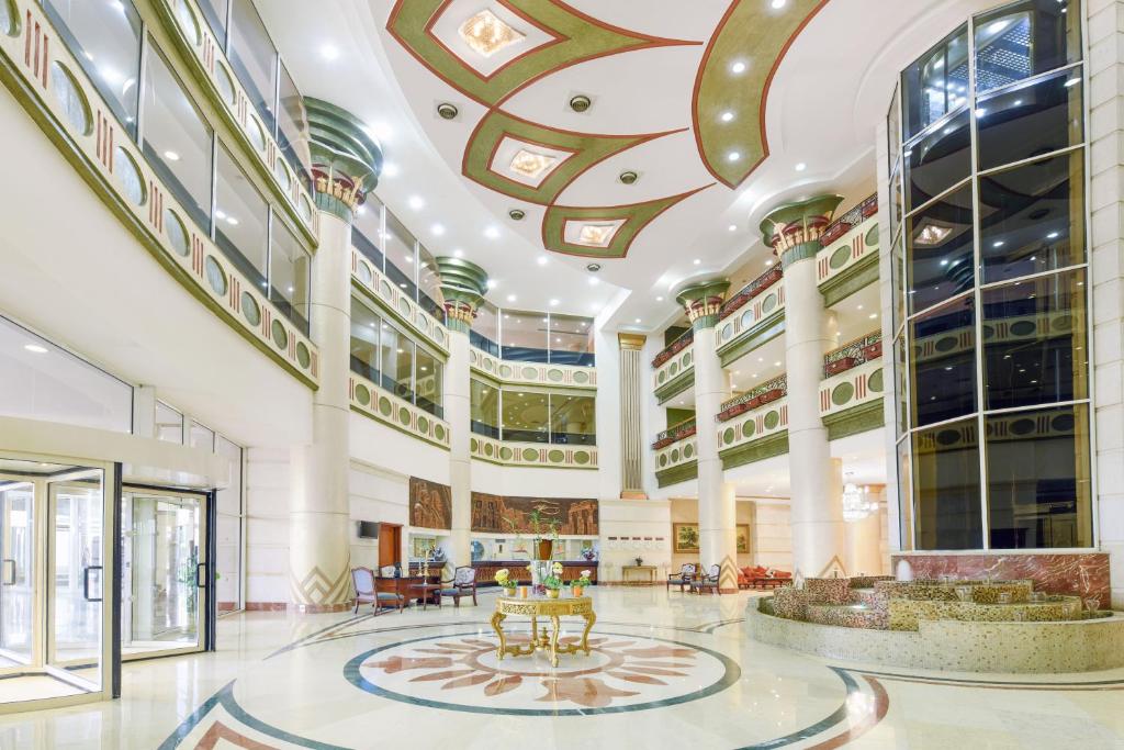 a large building with a lobby with tables and chairs at Tolip Aswan Hotel in Aswan
