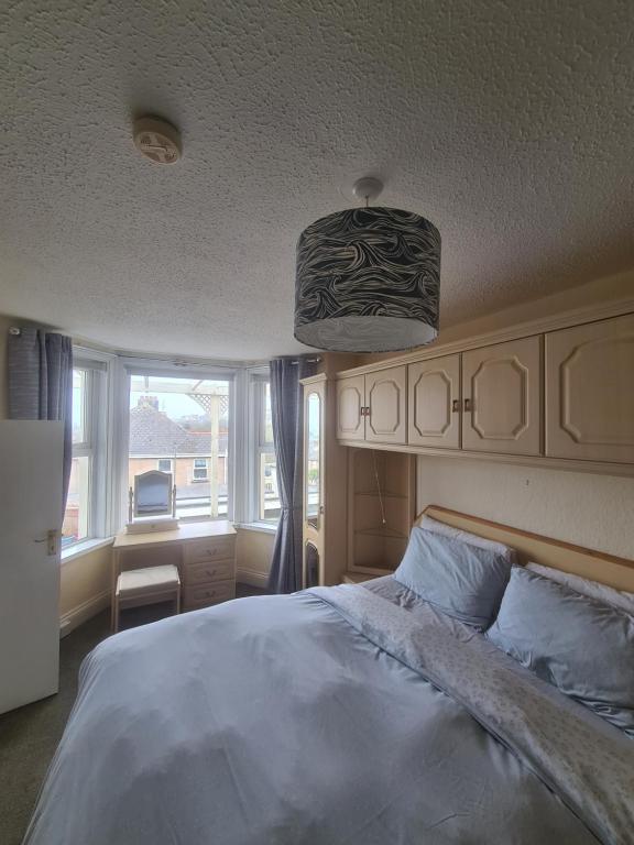 ein Schlafzimmer mit einem großen Bett und einem großen Fenster in der Unterkunft The Trelinda Guest House in Newquay
