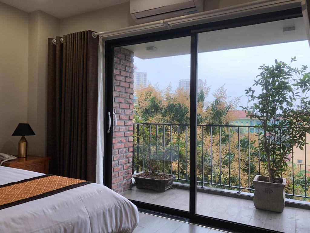 Postel nebo postele na pokoji v ubytování Moc Hoang Hotel