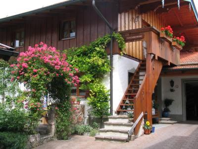 a house with stairs and flowers in front of it at Ferienwohnung Hell Claudia in Schleching