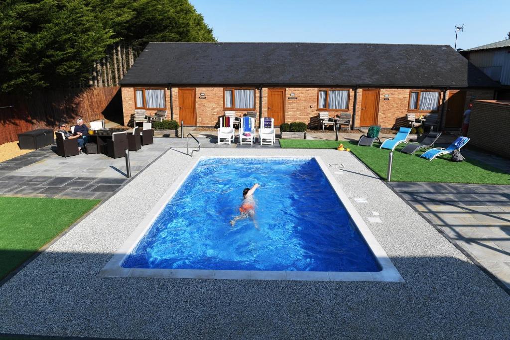 哈靈沃斯的住宿－斯潘霍旅館，在一个院子的游泳池里的人