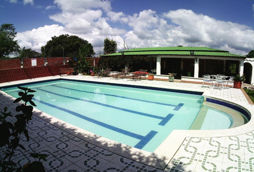 a large swimming pool in front of a house at Caraná in Pueblo Tapao