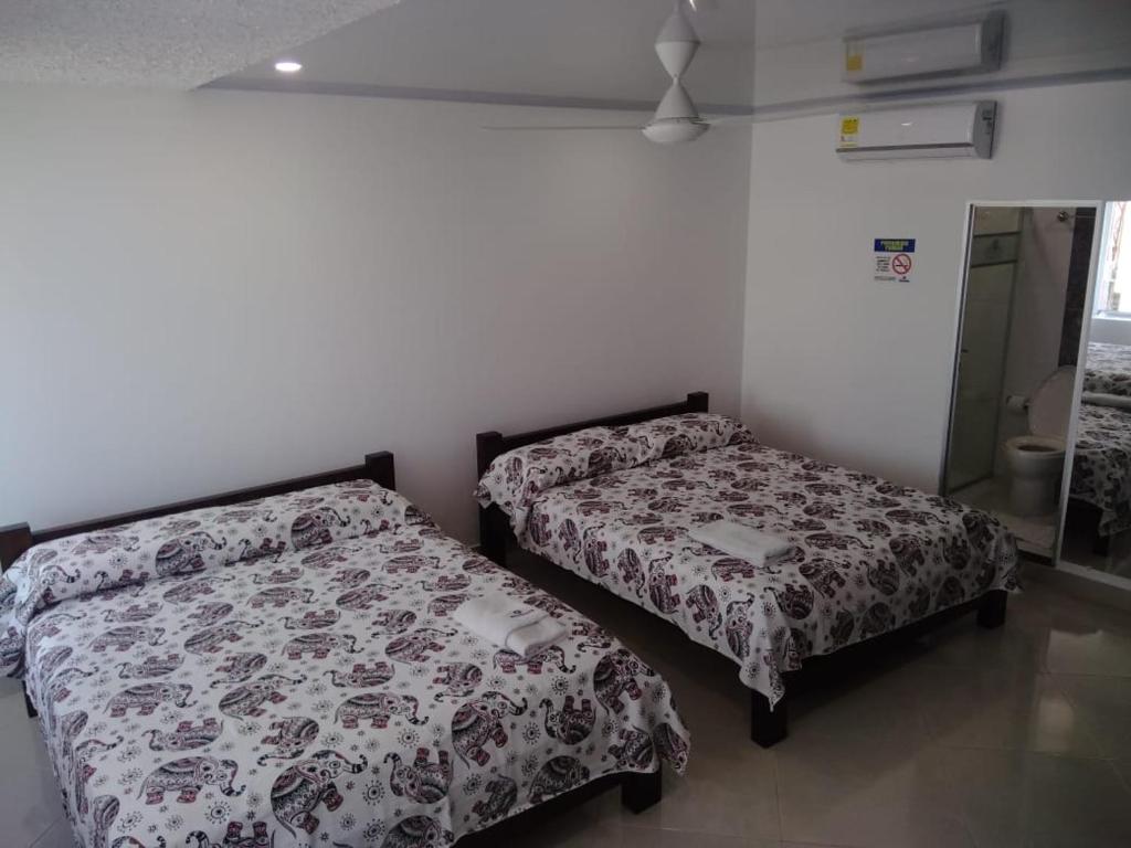 Postel nebo postele na pokoji v ubytování HOTEL TANIA