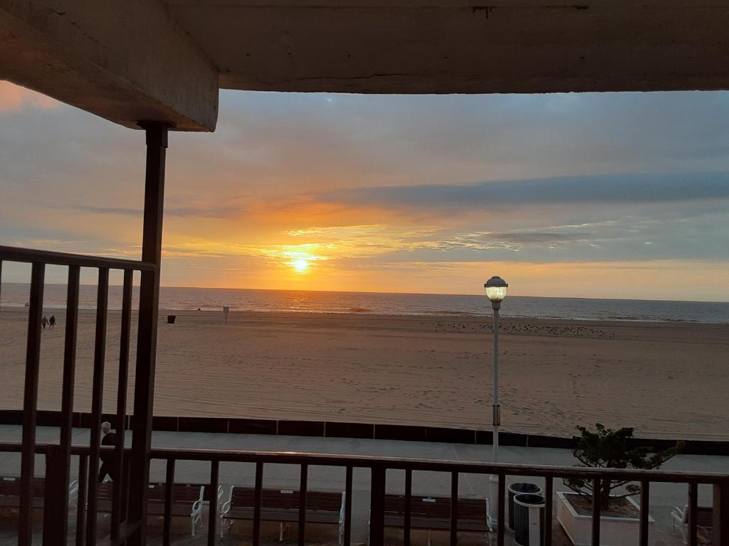 a sunset on the beach with a street light at Rideau Oceanfront Motel in Ocean City